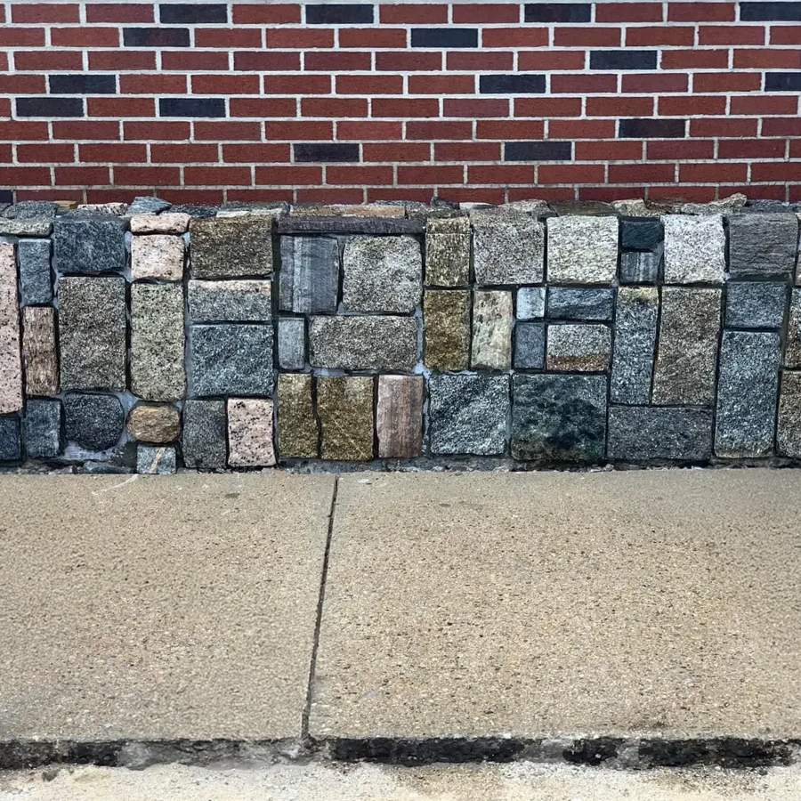 a brick wall with a brick wall behind it