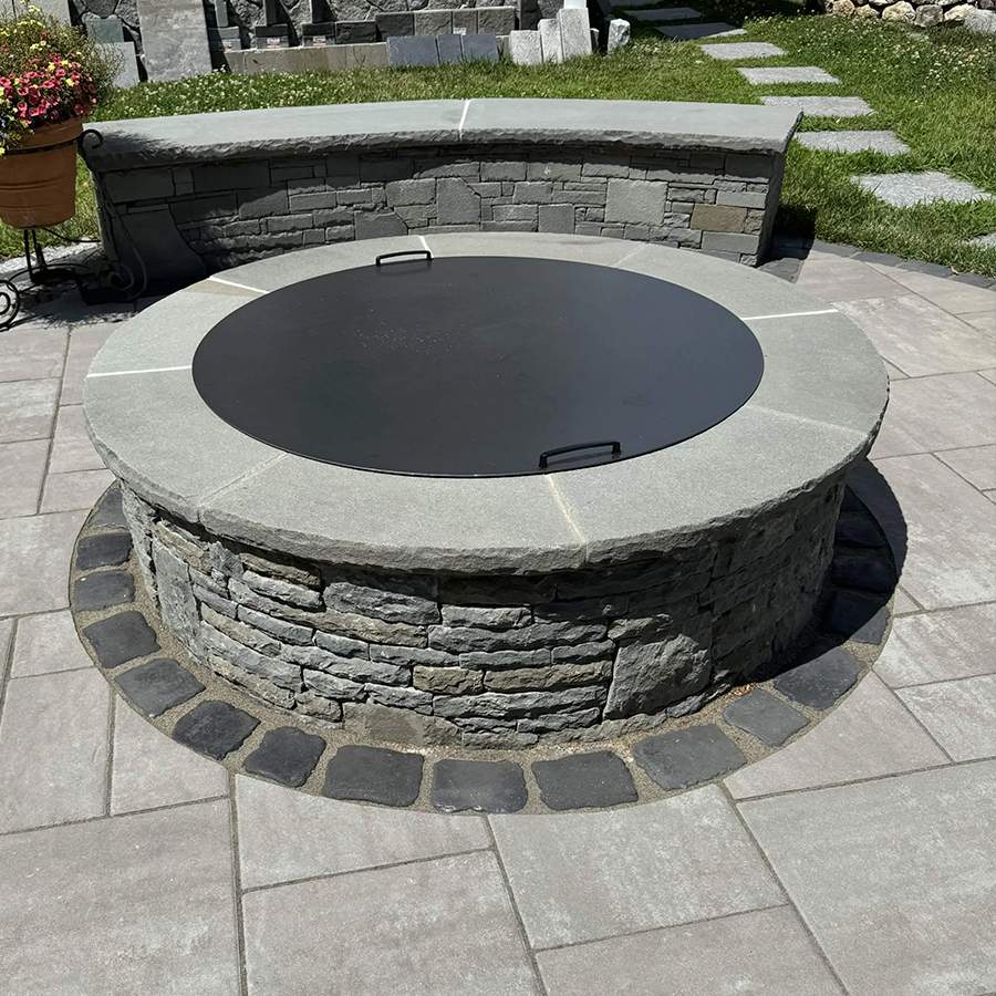 a fire pit with a stone bench