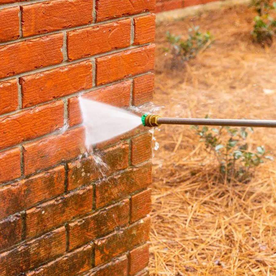 a water spraying a brick wall